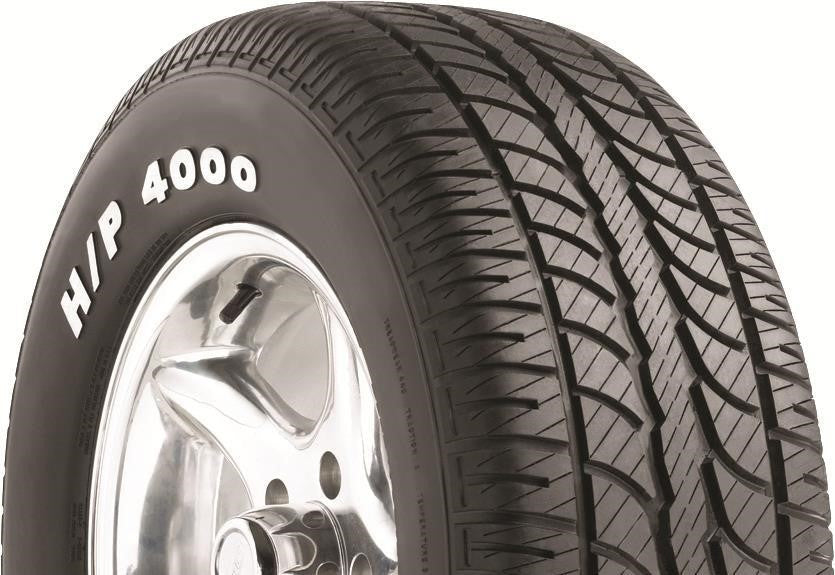 Angled view of Hercules H/P 4000 295/50R15 performance touring tire showing solid center rib and balanced tread blocks for stability.